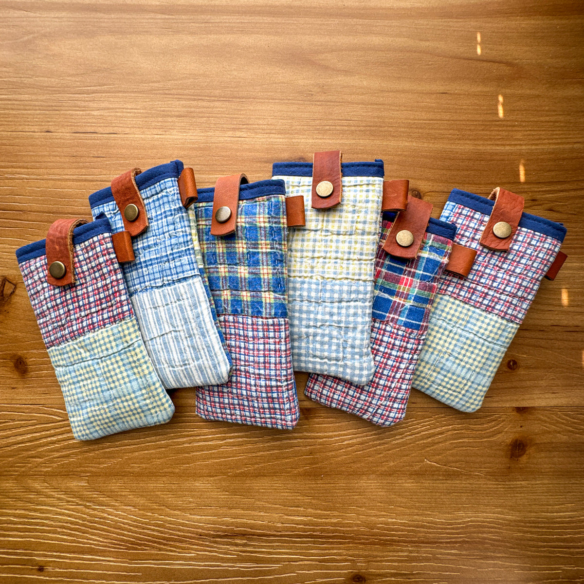 Group of rescued quilt glasses pouches with chrome-tanned leather snap closures