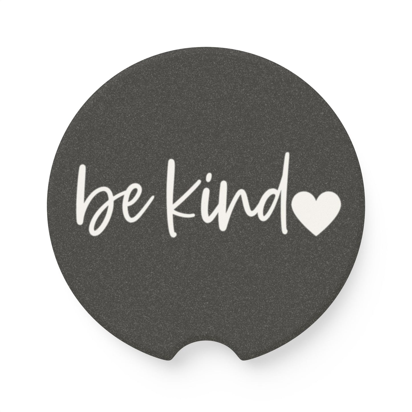Black car coaster with 'be kind' text and heart symbol on a white background