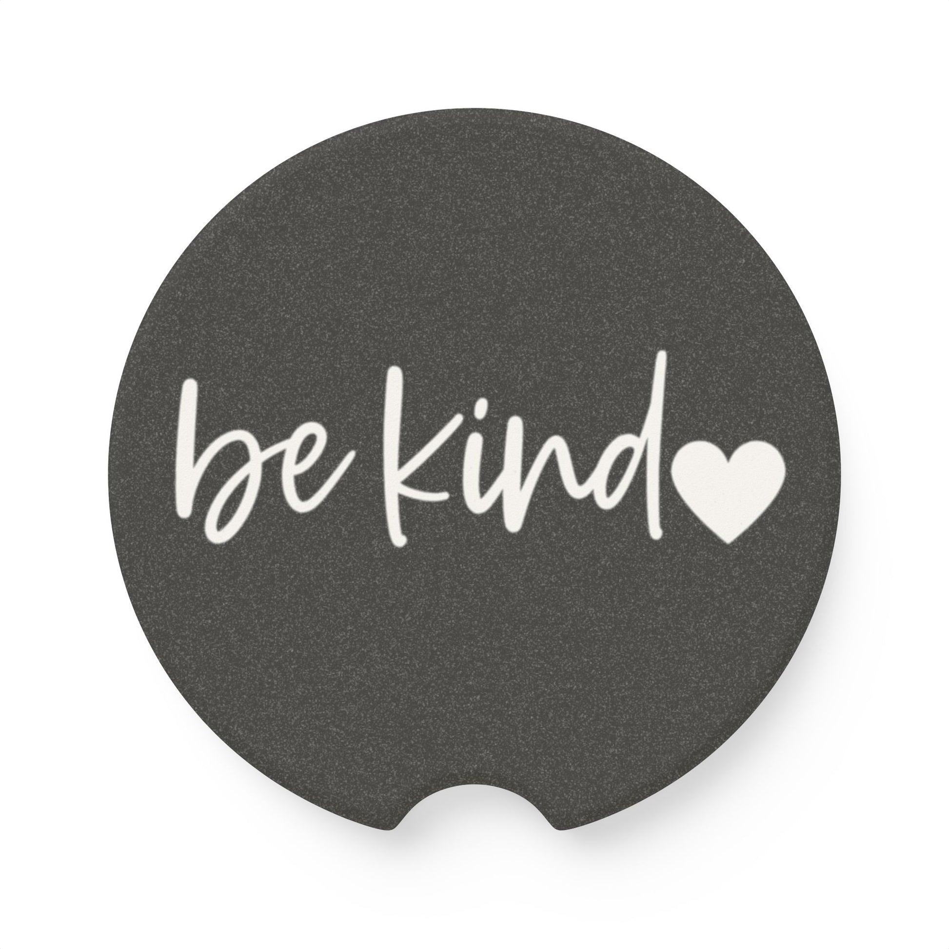 Black car coaster with 'be kind' text and heart symbol on a white background
