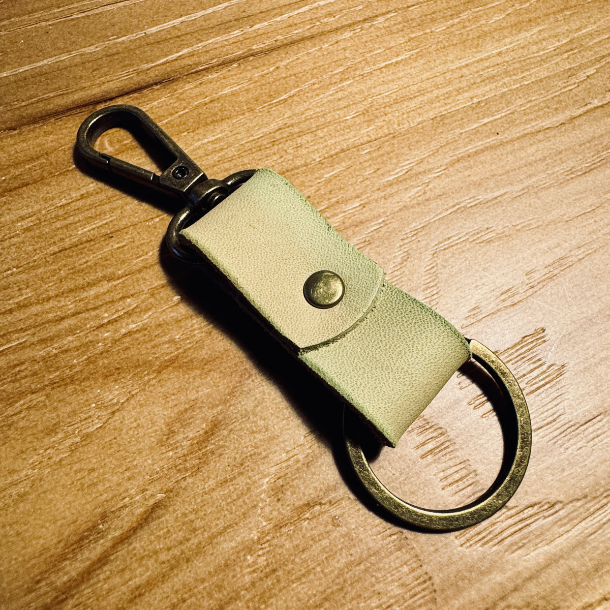 Faded Green minimalist leather keychain with antique brass hardware