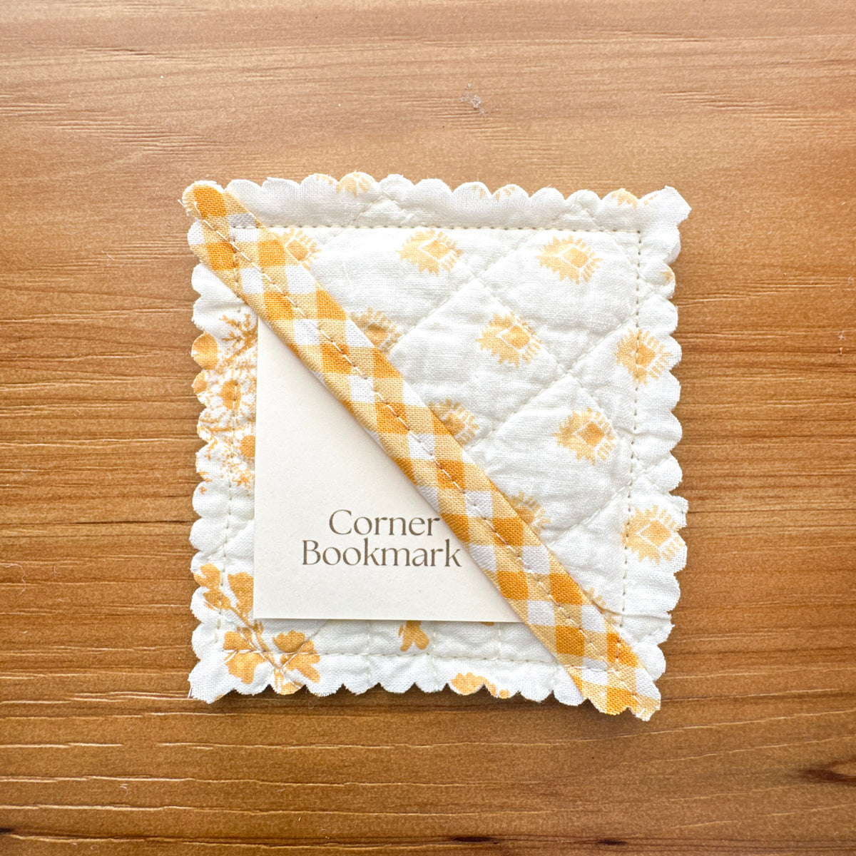 Handmade corner bookmark made from rescued goldenrod quilted fabric with gingham cotton