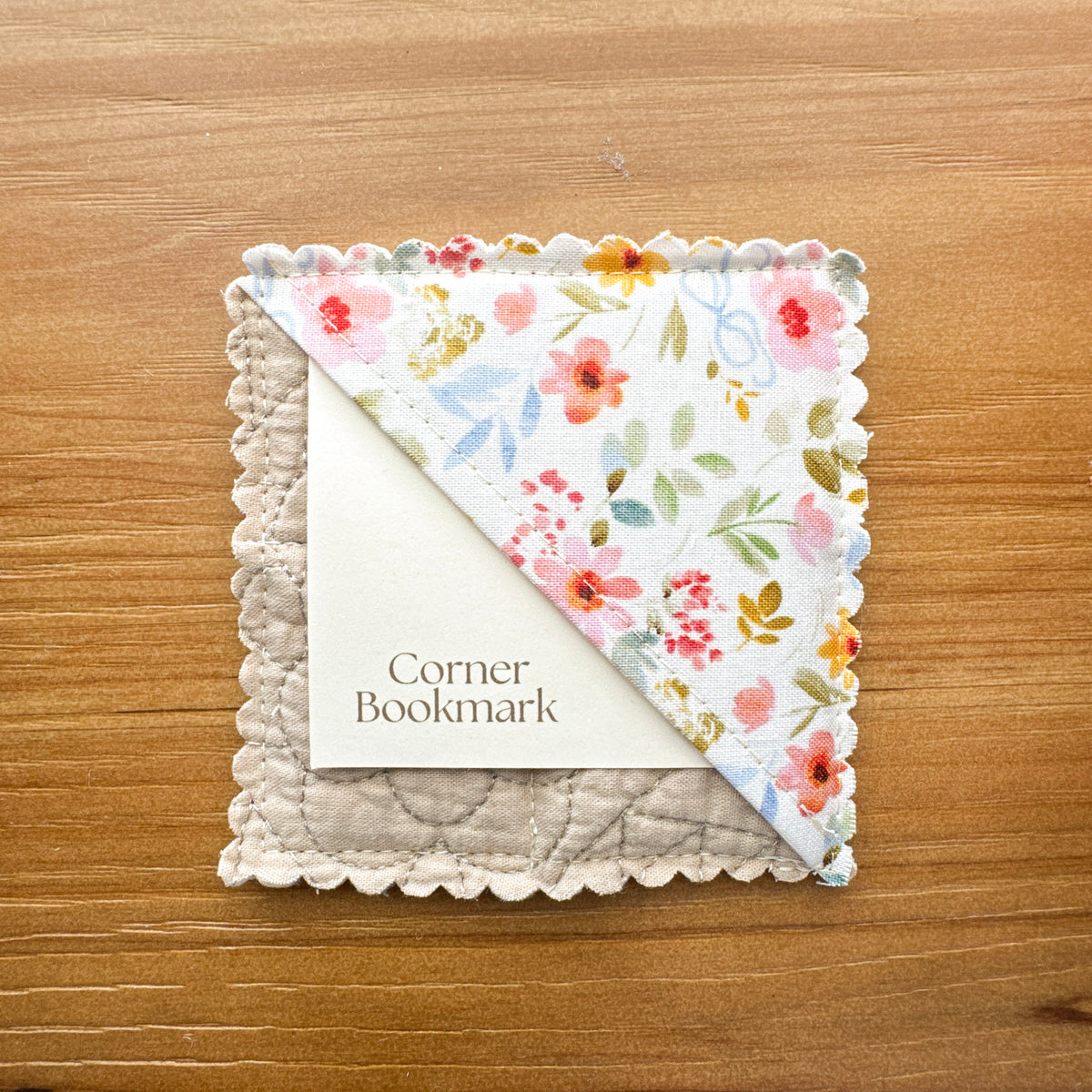 Handmade corner bookmark made from rescued floral quilted fabric with coordinating cotton