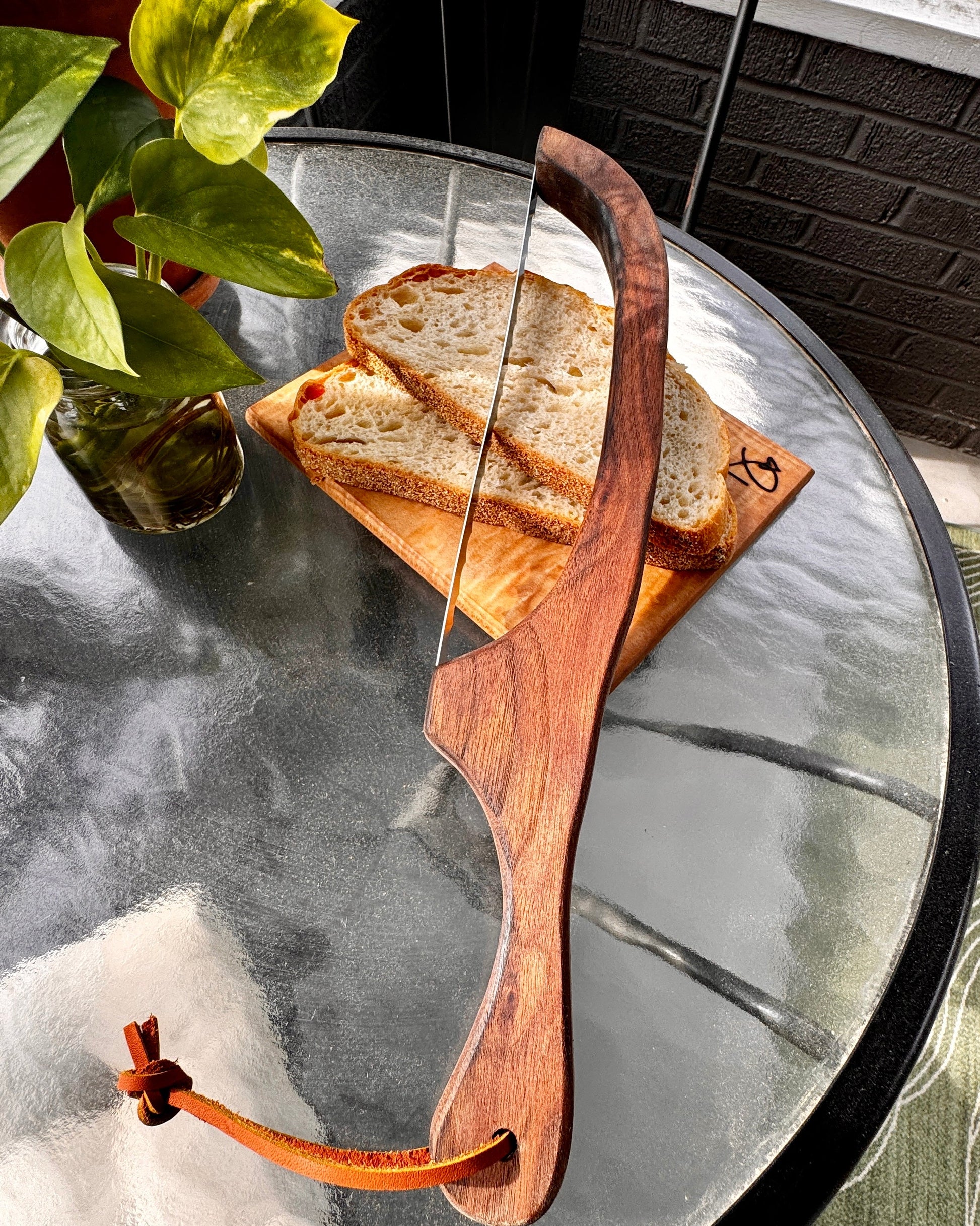 Wooden bow and arrow on a glass table with bread slices