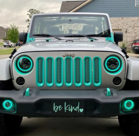 Be Kind black front license plate installed on teal Jeep Wrangler
