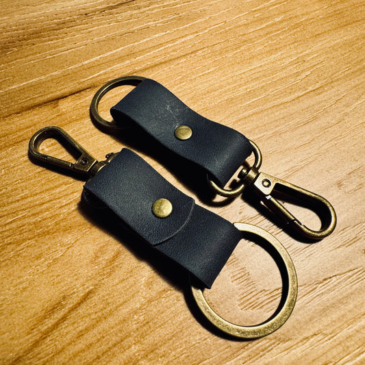 Absolute Black minimalist leather keychain with antique brass hardware