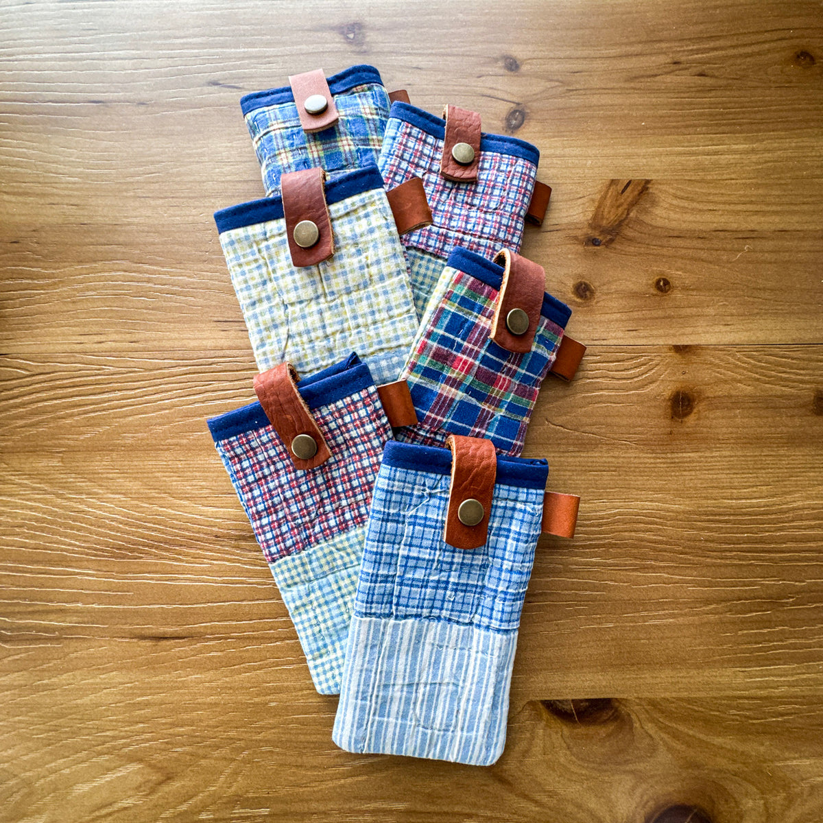 Assorted rescued quilt glasses pouches with chrome-tanned leather snap closures