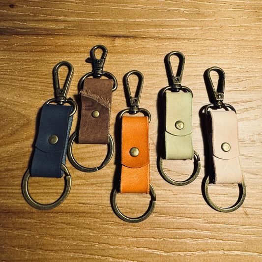 Handcrafted minimalist leather keychains in assorted colors with antique brass hardware