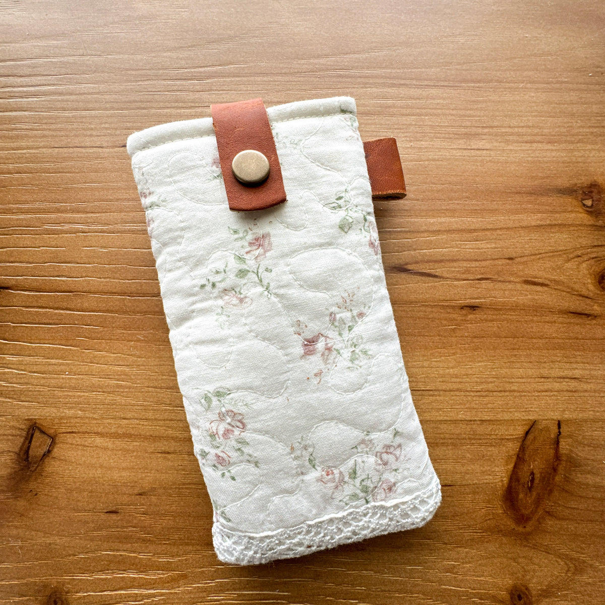 Light floral rescued quilt glasses pouch with chrome-tanned leather snap closure