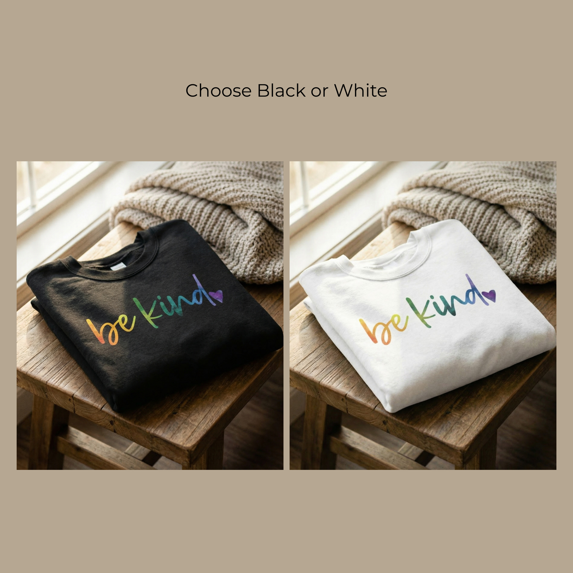 Two "Be Kind" rainbow crewneck sweatshirts in Midnight Black and Heirloom White are shown folded on a rustic wooden stool. The hand-lettered rainbow gradient and purple heart graphic are displayed clearly on both colors, highlighting the vibrant DTG print quality of this 1 Corinthians 16:14 inspired apparel.