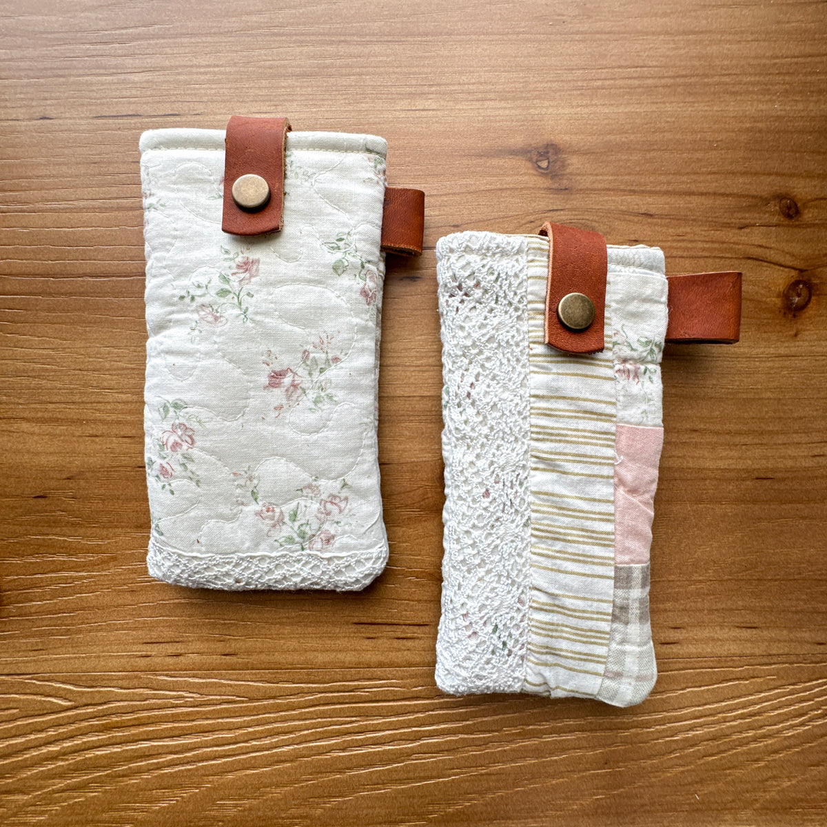 Two light colored rescued quilt glasses pouches with lace and chrome-tanned leather snap closures