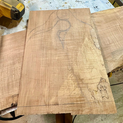 Pencil layout drawn on a walnut slab before cutting a handmade charcuterie board in the workshop